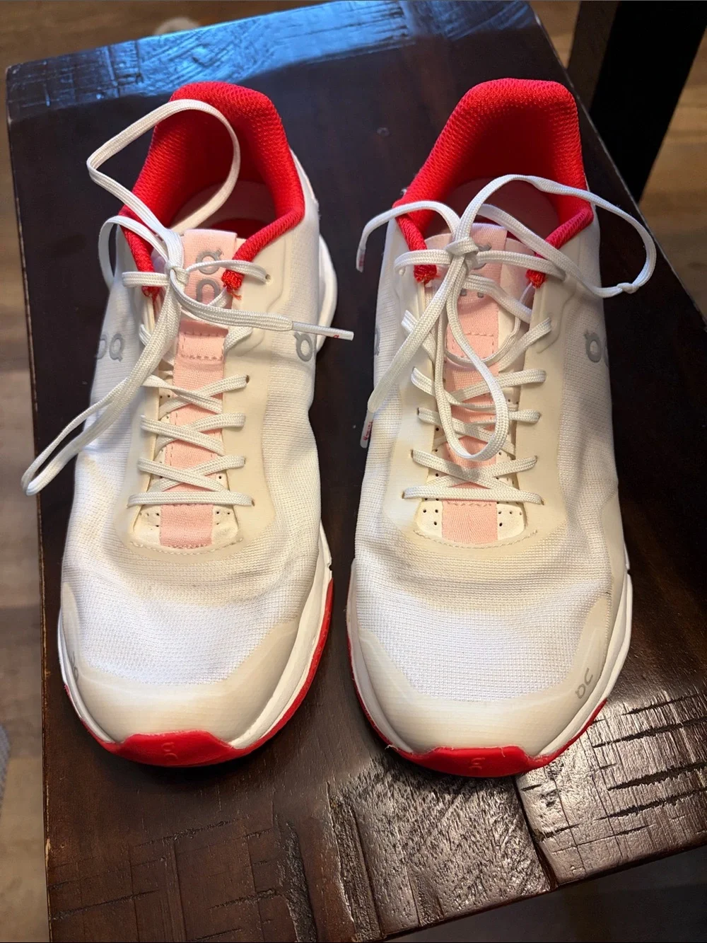 On Running White Athletic Shoes with Pink and Red Accents